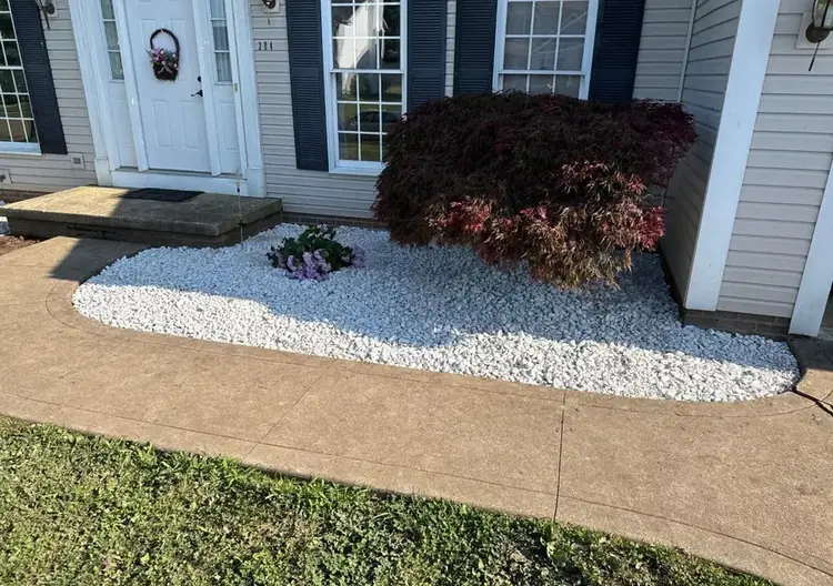 Decorative stone landscape bed near a home entry installed by Going Yard